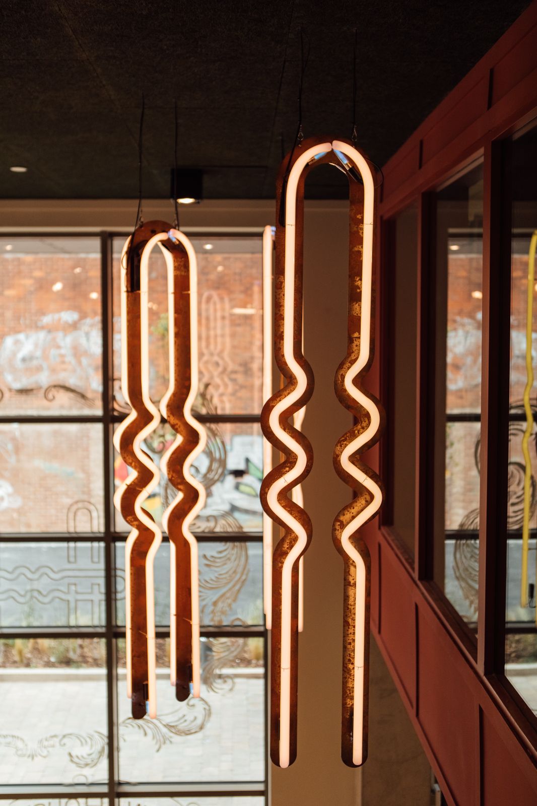 Neon hairpins by Neon workshop suspended within the Hairpin House apartment building (BTR) entrance.